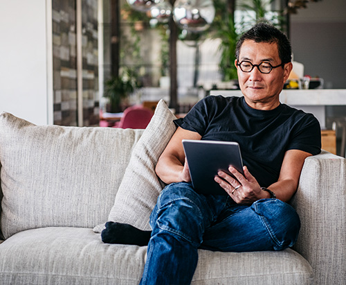 Man reading corporate training solutions on iPad