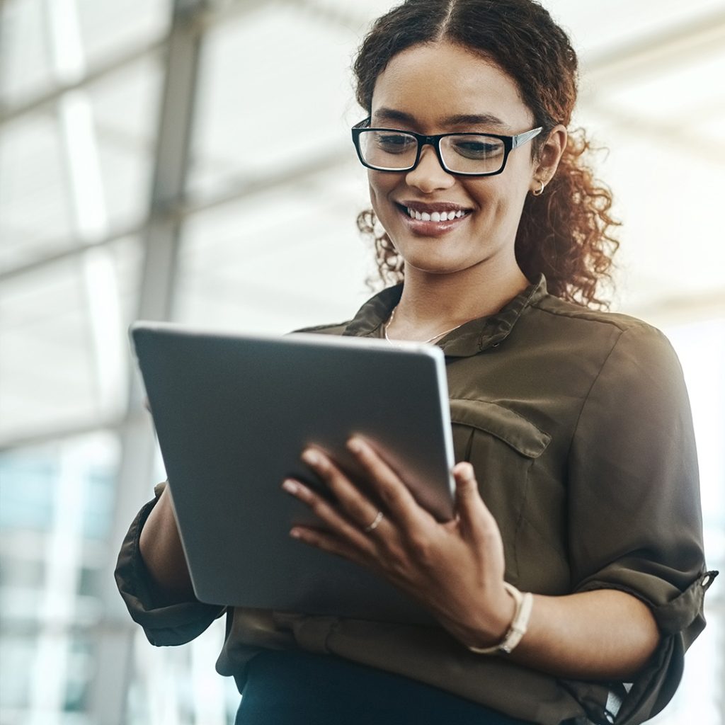 Woman holding an iPad looking at storyline e-learning