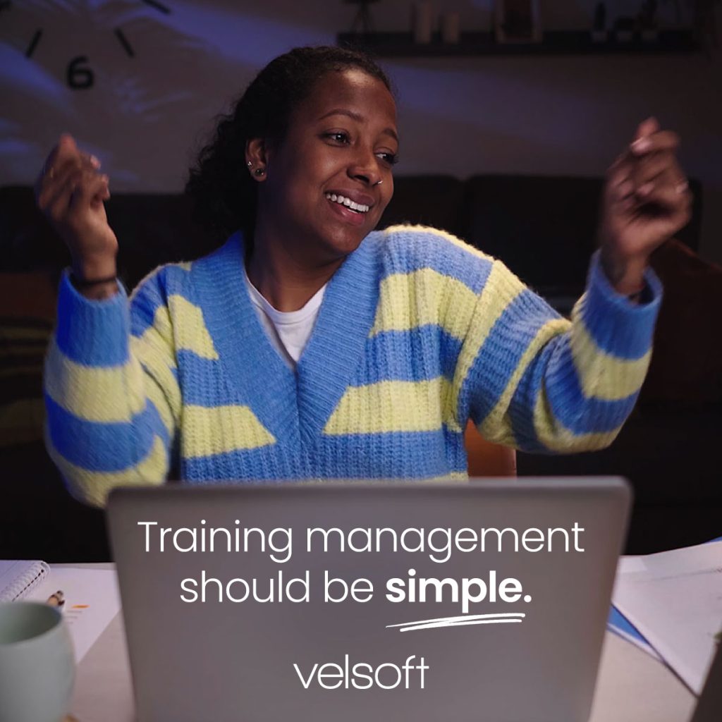 a woman sitting at her laptop dancing