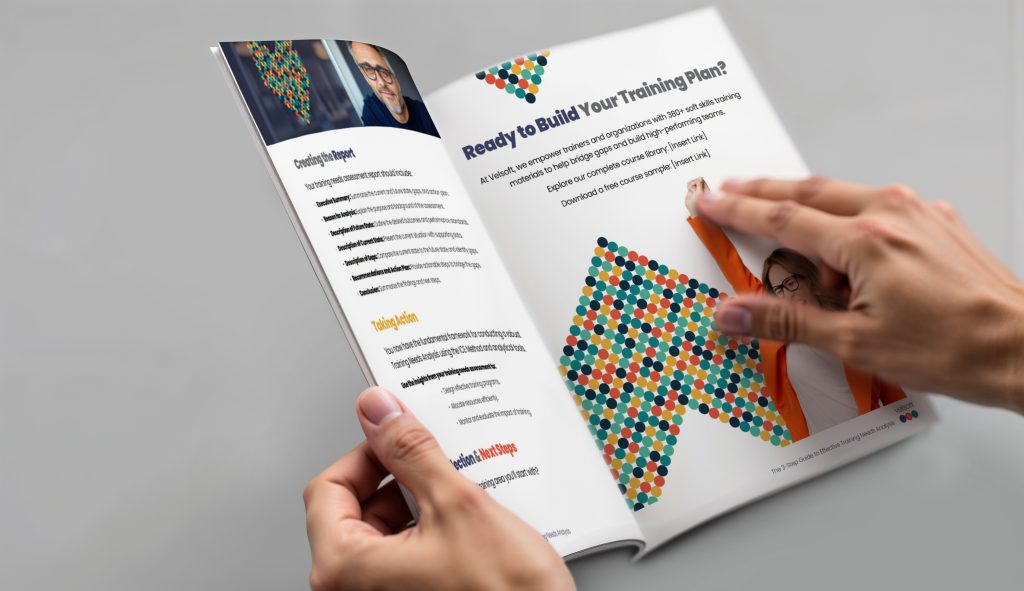 Person flipping through the training needs assessment guide