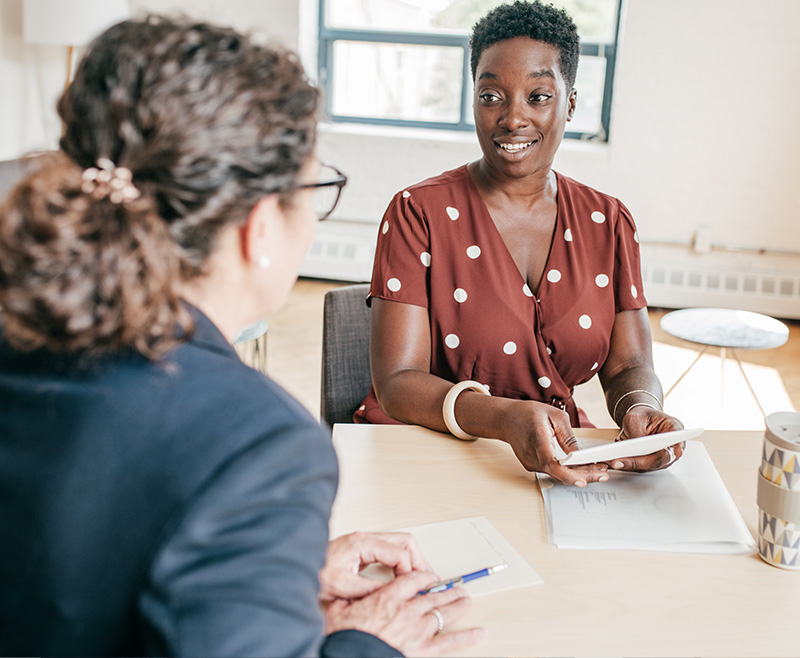 Two women discussing the corporate university platform